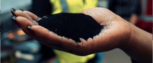 A hand holding micronized rubber powder